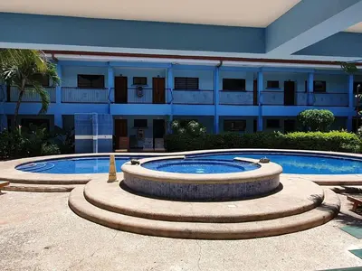 a building with a large pool in front of a building at Marina Loft Condos 212 in Coco