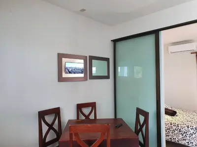 a room with a table and chairs and a bed at Marina Loft Studio 224 in Coco