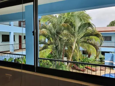 a palm tree is seen through a window at Marina Loft Studio 224 in Coco