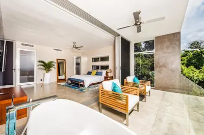 a master bedroom with a bed and a balcony at Costa Rica Luxury Ocean View in Playa Ostional