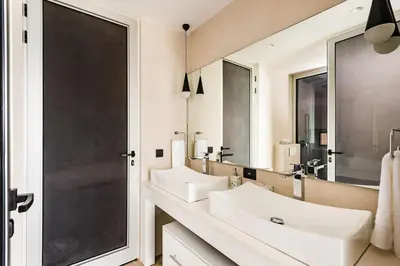 a bathroom with two sinks and a large mirror at Costa Rica Luxury Ocean View in Playa Ostional