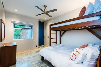 a bedroom with two bunk beds and a window at Costa Rica Luxury Ocean View in Playa Ostional