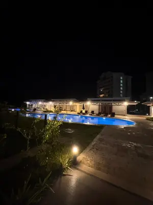 a view of a building at night with blue lights at Jacó Pacífico in Jacó