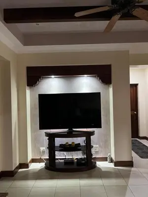 a living room with a flat screen tv on a wall at Condo Roldan macaw 12 Jaco Unique,with access to the sea in Jacó
