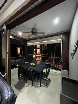 a dining room with a black table and chairs at Condo Roldan macaw 12 Jaco Unique,with access to the sea in Jacó