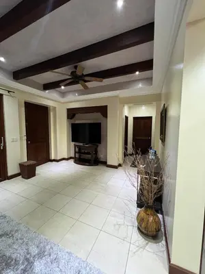 a living room with a ceiling fan and a television at Condo Roldan macaw 12 Jaco Unique,with access to the sea in Jacó