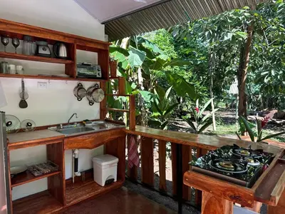 a kitchen with a sink and a counter top at Cabañas Playa Cedros in Puntarenas