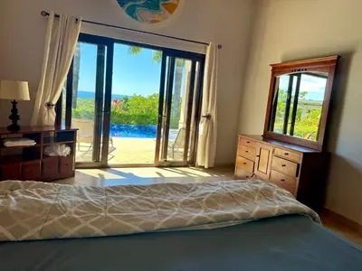a bedroom with a bed and a large sliding glass door at Villas with breathtaking seaview in Marbella