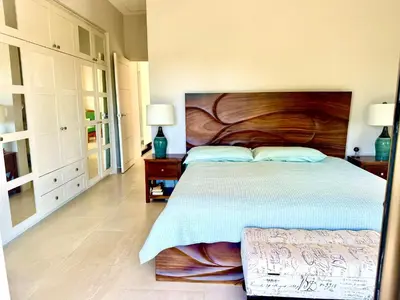 a bedroom with a large bed with a wooden headboard at Villas with breathtaking seaview in Marbella