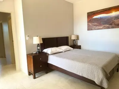 a bedroom with a bed with two night stands and two lamps at Villas with breathtaking seaview in Marbella