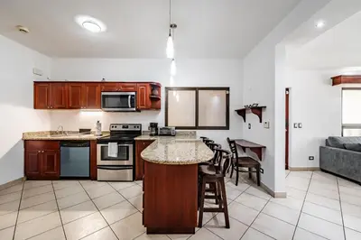 a kitchen with an island in a living room at Beautiful Condo, Tamarindo Costa Rica in Huacas