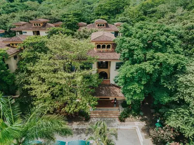an aerial view of a house surrounded by trees at Beautiful Condo, Tamarindo Costa Rica in Huacas