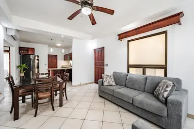 a living room with a couch and a table at Beautiful Condo, Tamarindo Costa Rica in Huacas