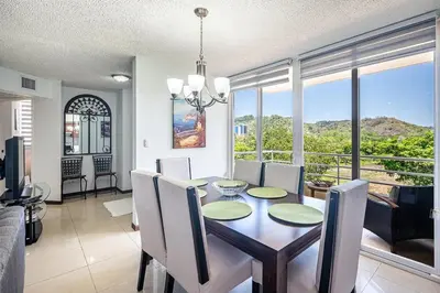 a dining room with a table and chairs with a view at Beautiful Jaco Apartment CL 1-23 - Just a short walking distance to the beach in Jacó