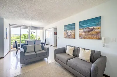 a living room with two chairs and a couch at Beautiful Jaco Apartment CL 1-23 - Just a short walking distance to the beach in Jacó