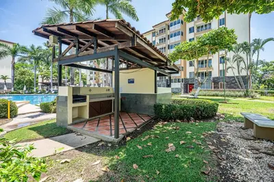 a building with a shelter in a park at Beautiful Jaco Apartment CL 1-23 - Just a short walking distance to the beach in Jacó