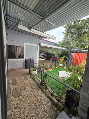 an outside view of a house with a yard at Casita el Jardin in Nuevo Arenal
