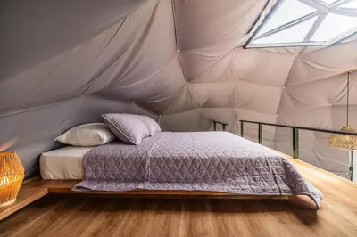 a bedroom with a bed in a tent at Domo Mágico en las Alturas, EL SOL in San José