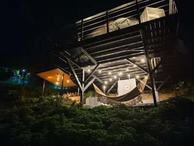 a building with a hammock under it at night at Domo Mágico en las Alturas, EL SOL in San José