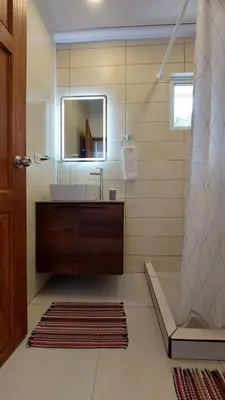 a bathroom with a sink and a mirror at Villas Pura Vida - Marañón in Puntarenas