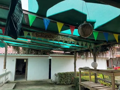 awning over a patio with a table in front of a building at Apartamento equipado, con amplia piscina in Paquera
