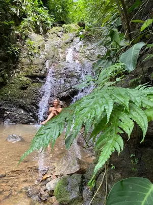 a man bathing in a waterfall in a river at Private room in nature in Coronado