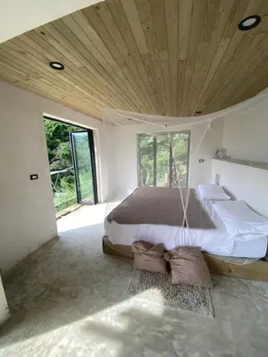 a bedroom with a large bed with a wooden ceiling at Private room in nature in Coronado