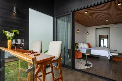 a bedroom with a bed and a dining room with a table at ÉWA Homes Monteverde in Monteverde Costa Rica