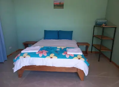 a bedroom with a bed with a colorful comforter at Cabina el atardecer in Monteverde Costa Rica