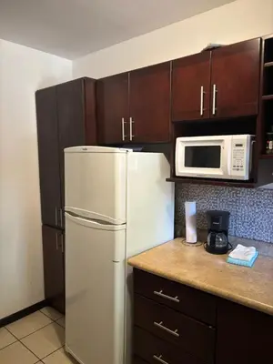 a kitchen with a white refrigerator and a microwave at Cocomarindo 63 in Coco