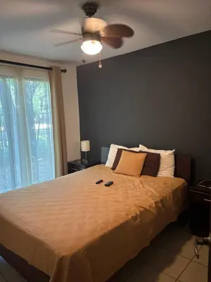 a bedroom with a large bed with a ceiling fan at Cocomarindo 63 in Coco