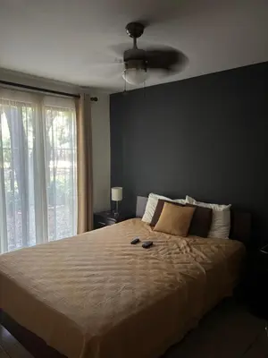 a bedroom with a large bed with a ceiling fan at Cocomarindo 63 in Coco