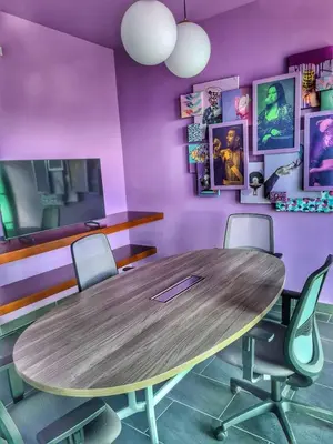a conference room with a wooden table and chairs at Top-floor overlooking uptown with AC & parking in San José