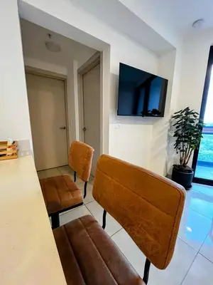 a living room with a table and two chairs at Top-floor overlooking uptown with AC & parking in San José