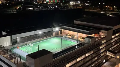 a swimming pool on the roof of a building at night at Top-floor overlooking uptown with AC & parking in San José