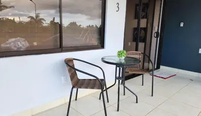 a table and chairs in a room with a window at Tropical Noir at Family Lodge in Jabillos