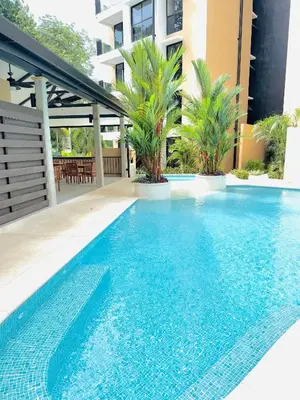 a swimming pool in front of a building at Apartamento en condominio Torres del Mar, Jacó in Jacó