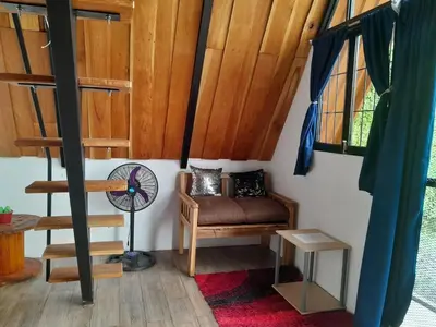 a room with a couch and a fan and windows at Angel View Alojamiento entero en Atenas in San Isidro