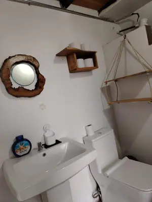 a bathroom with a sink and a toilet and a mirror at Angel View Alojamiento entero en Atenas in San Isidro