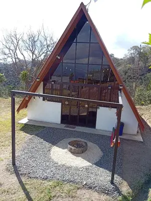 a small house with a porch and a swing at Angel View Alojamiento entero en Atenas in San Isidro