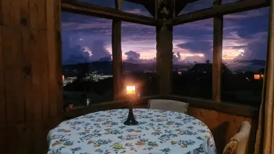 a table in a room with a window with a candle on it at Cabaña Rancho Don Marino in Cartago