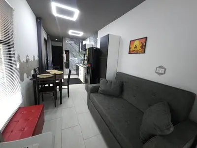 a living room with a couch and a kitchen at Flatbirds Beautiful Small Apartment in San José Pinilla