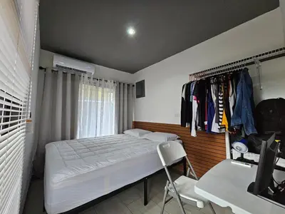 a bedroom with a bed and a chair and a desk at Flatbirds Beautiful Small Apartment in San José Pinilla