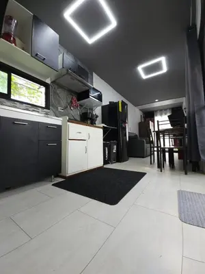 a kitchen with white cabinets and a black ceiling at Flatbirds Beautiful Small Apartment in San José Pinilla