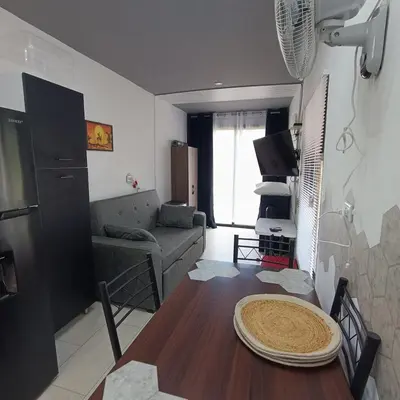 a living room with a table and a couch at Flatbirds Beautiful Small Apartment in San José Pinilla