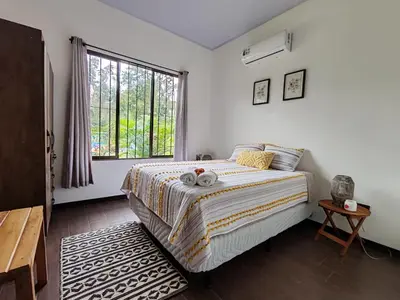 a bedroom with a bed with two towels on it at La Finca Tovar- Casita in San Ramón