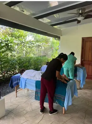 a group of women in a room with beds at La Finca Tovar- Casita in San Ramón