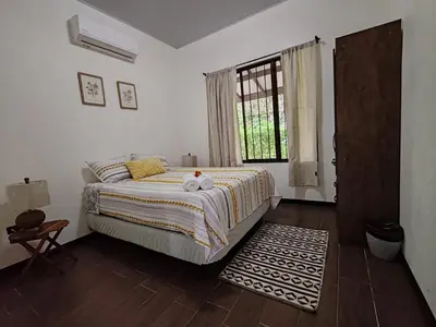 a bedroom with a bed with two stuffed animals on it at La Finca Tovar- Casita in San Ramón