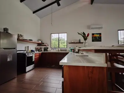a kitchen with a refrigerator and a counter top at La Finca Tovar- Casita in San Ramón