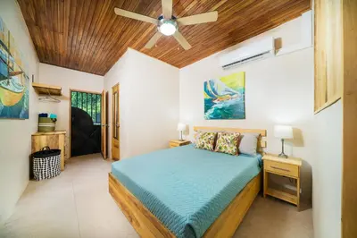 a bedroom with a bed and a ceiling fan at Pequeno Paraiso - New Studio, 10min walk to Potrero beach, tranquil - Unit D in Potrero